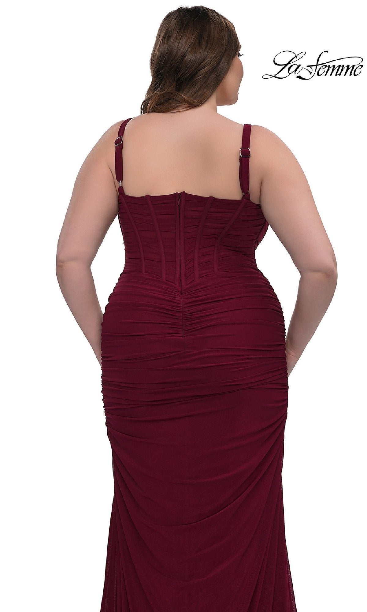 A woman is shown from the back in the Plus-Size Sexy Long Prom Dress: La Femme 32402, featuring a fitted burgundy silhouette with a corset-style bodice, ruched detailing, and adjustable straps.